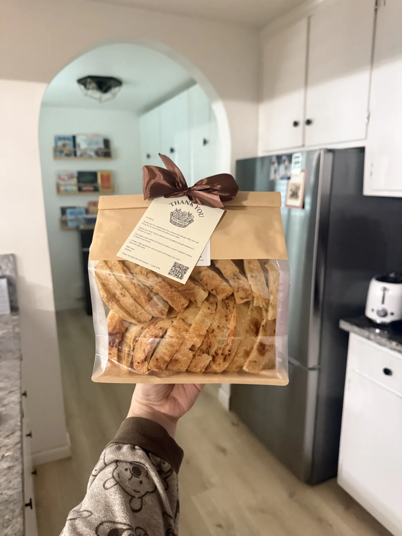 Five Loaves sourdough slices packaged in a gift bag with a thank-you card
